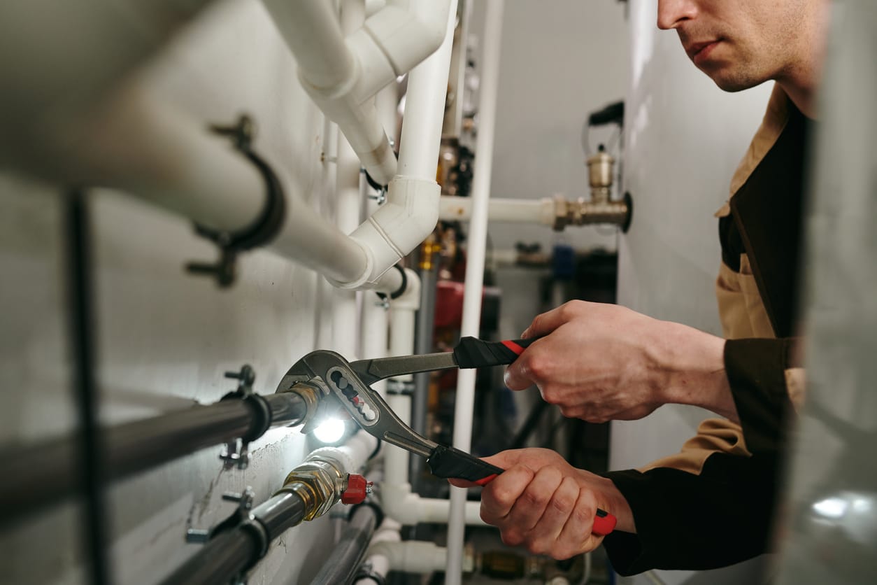 Plumbers maintaining commercial plumbing pipes in Danville
