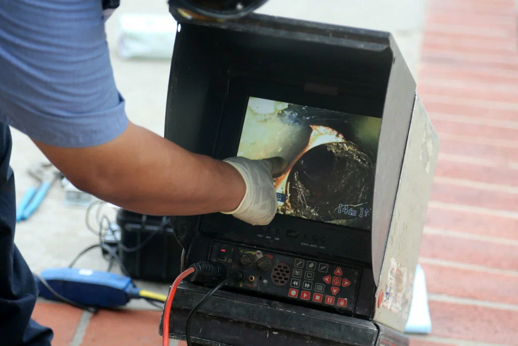 Technician viewing a drain inspection camera in Danville